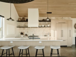 Gourmet kitchen with 36" 5 burner gas range, 42 " built in Jenn-Aire Fridge.