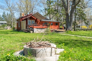 View of cabin from firepit in spring 2020