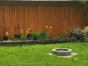 View of firepit from deck in spring 2022