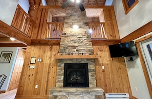 Gas fireplace with a glimpse of lofted bedroom