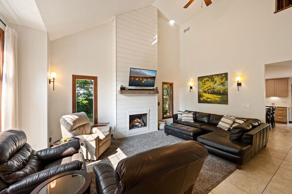 Spacious living room features natural light and gas fireplace