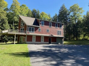 View of the house from the driveway.  Now with a hot tub under the deck.