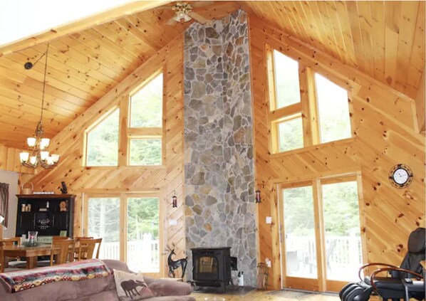 Light-filled, high-ceilinged main room with a pellet stove for those cold nights