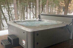 Hot tub overlooking woods and stream.  Relax after a day of cycling or skiing!