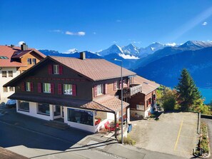 Sky, Property, Window, Building, Mountain, World, Cloud, Plant, Slope, House