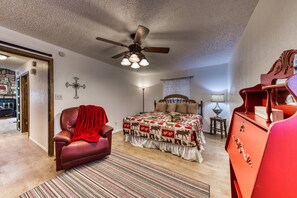 Master bedroom with King sized Bed, Seating, TV, and On-Suite Bathroom.