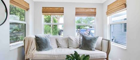 Relax on this comfy couch in the sunroom.