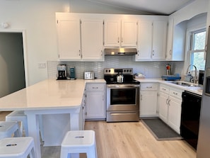 Fully equipped kitchen with large eat-in island that sits 7