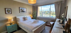 Main bedroom with built-in wardrobes, portable heating, harbour views + TV