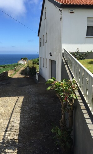 Lane view of the property, garage door, view of back yard and Atlantic Ocean