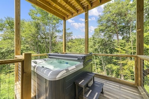 Soak in our hot tub while enjoying stunning views of the surrounding landscape.
