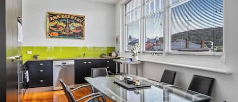 An open plan dining area and kitchen offers ample space to cook up a storm and enjoy a meal overlooking the surrounding landscape.