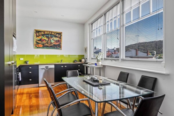 An open plan dining area and kitchen offers ample space to cook up a storm and enjoy a meal overlooking the surrounding landscape.