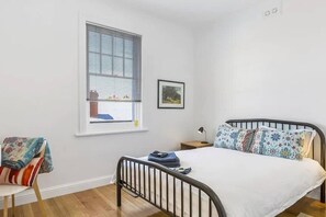 The first bedroom is set with a comfortable queen bed and a dedicated workspace so you can set your laptop up and work remotely.