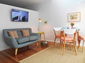 The cheery living and dining area offers a double sofabed and table to sit back and relax with a meal or a spot of TV