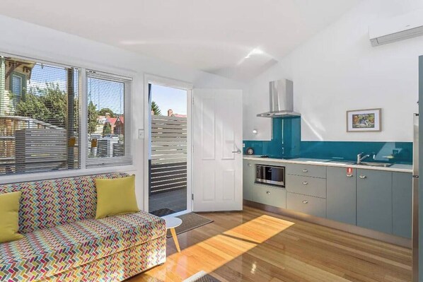 The compact kitchen is fully equipped to prepare meals at home with ease. 
