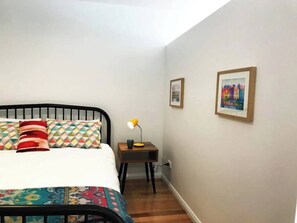 The queen bed is in a partially enclosed zone for added privacy and comfort.  