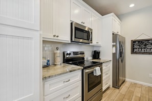 Full Size Kitchen with Island Bar Seating equipped with Keurig Coffee Machine