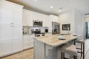 Full Size Kitchen with Island Bar Seating equipped with Keurig Coffee Machine