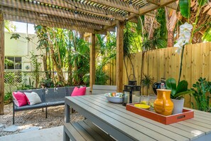 The outdoors. There is access through the living room to the back patio. There is outdoor dining and bench seating, a charcoal grill, and a large 2-person hammock. The outdoors is a lovely place to relax and unwind in a quiet, tranquil setting.
