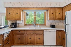 Fully equipped kitchen with dishwasher, toaster and keurig coffee maker.