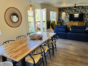 Spacious living room and dining area that opens up to beautiful deck with incred
