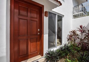 Front door with with keyless entry and small side garden
