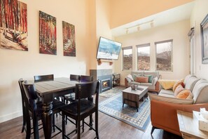 Great room with beautiful mountain views, plenty of seating, cozy fireplace & TV