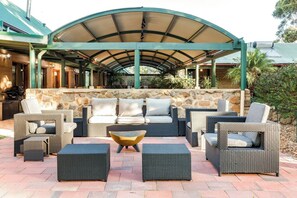A sprawling, sun-drenched open patio is perfect for your morning coffee or evening chats—surrounded by nature and styled for comfort and connection.