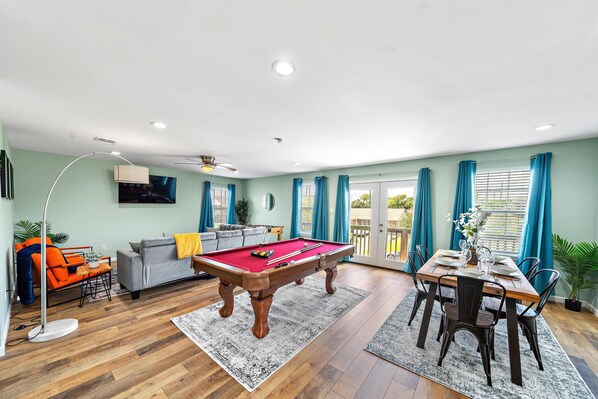 Full-size pool table and foosball table included.
