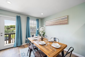 Spacious dining table that sits 6 with full tableware and silverware included.