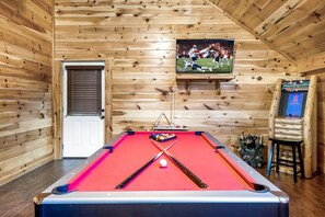 Enjoy endless fun in the game room, featuring a pool table for some friendly competition and lasting memories.
