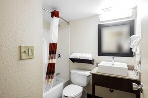 Bathroom with a shower and tub. The essential toiletries and towels are provided