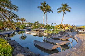 Relax and enjoy a drink in the pool side lounge chairs.