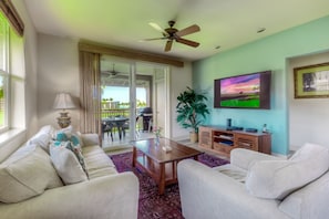 The spacious living room features golf course and ocean views.