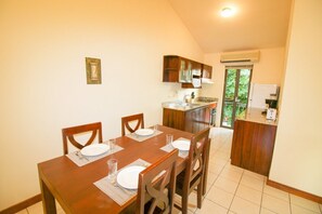 The dining space sits between the living area and kitchen space for easy conversation during meal prep.