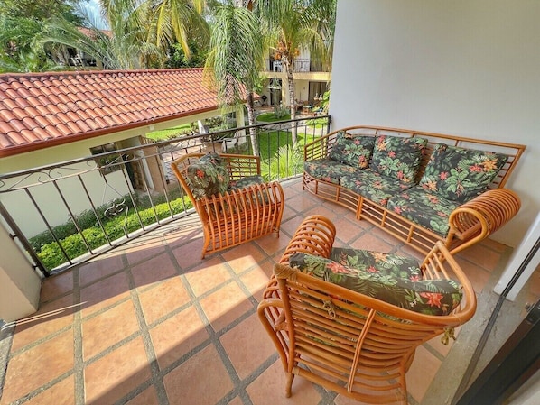 Comfortable patio furniture overlooking the community rancho - the shared pools are just on the other side of the building, providing privacy from the pool while just being steps from it.