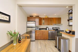 Full service kitchen with all amenities including full refrigerator and range.