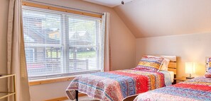 Bedroom #3 has a set of twin beds and a SmartTV.