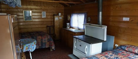 Cabin 2 is a cozy rustic cabin that features a wood-burning stove.