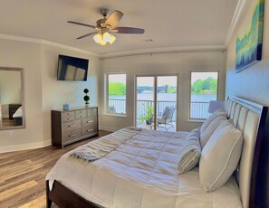 Enjoy lakefront views from the comfort of your kind bed.