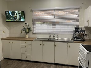Full kitchen with a 2nd smart TV and all of the tools needed to cook up a storm