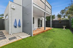 Enclosed rear yard and deck area with outdoor shower