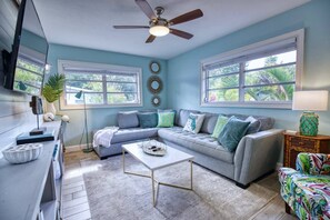 Living Room featuring a large sectional sofa and a 55" smart TV. Sit and enjoy the abundance of natural light.