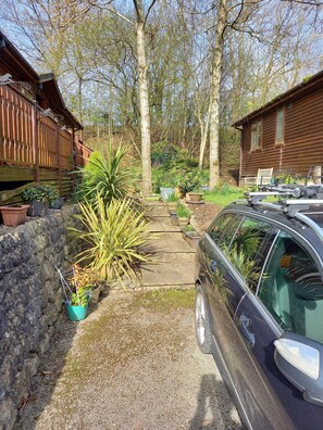 From car parking area showing steps up to lodge and garden area