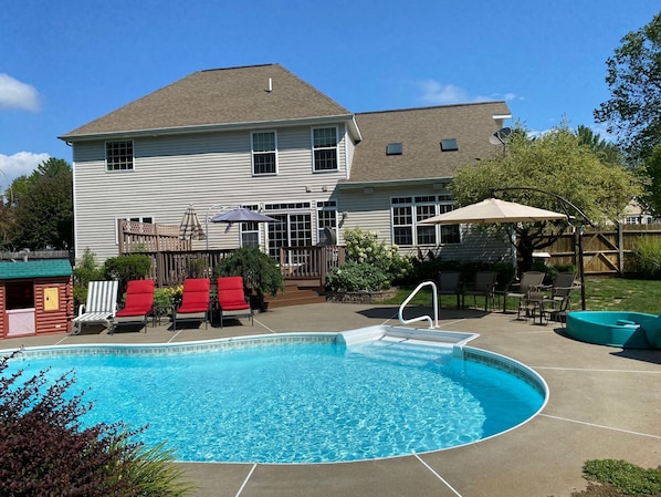 Luxurious pool area with 4 lounge chairs, patio furniture, and much more!