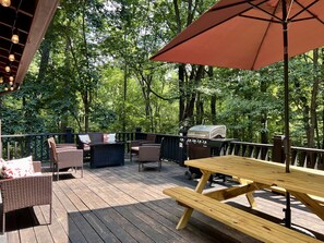 Spacious deck with gas fire-pit, BBQ grill and picnic table.