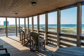 Open porch and Adirondack chairs make you want to stay outside in the breeze