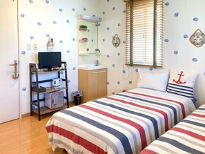 Yacht room: Accented with tricolor bedspreads