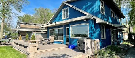 Back deck with patio furniture and 4-burner propane grill